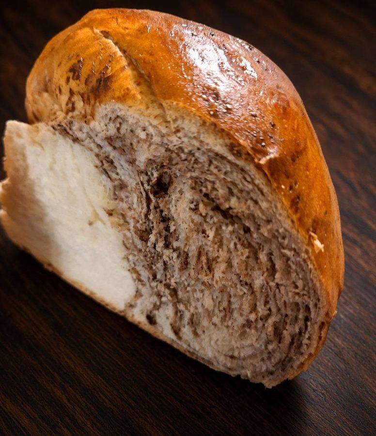 Cut challah showing the cocoa swirl