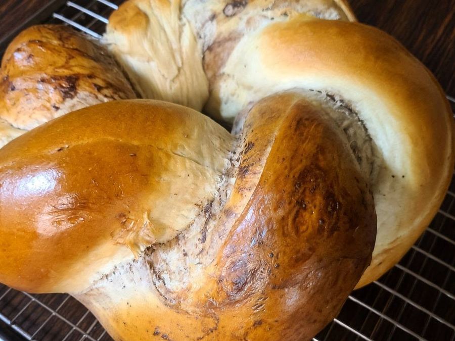 Cocoa-swirl challah crown on a cooling rack